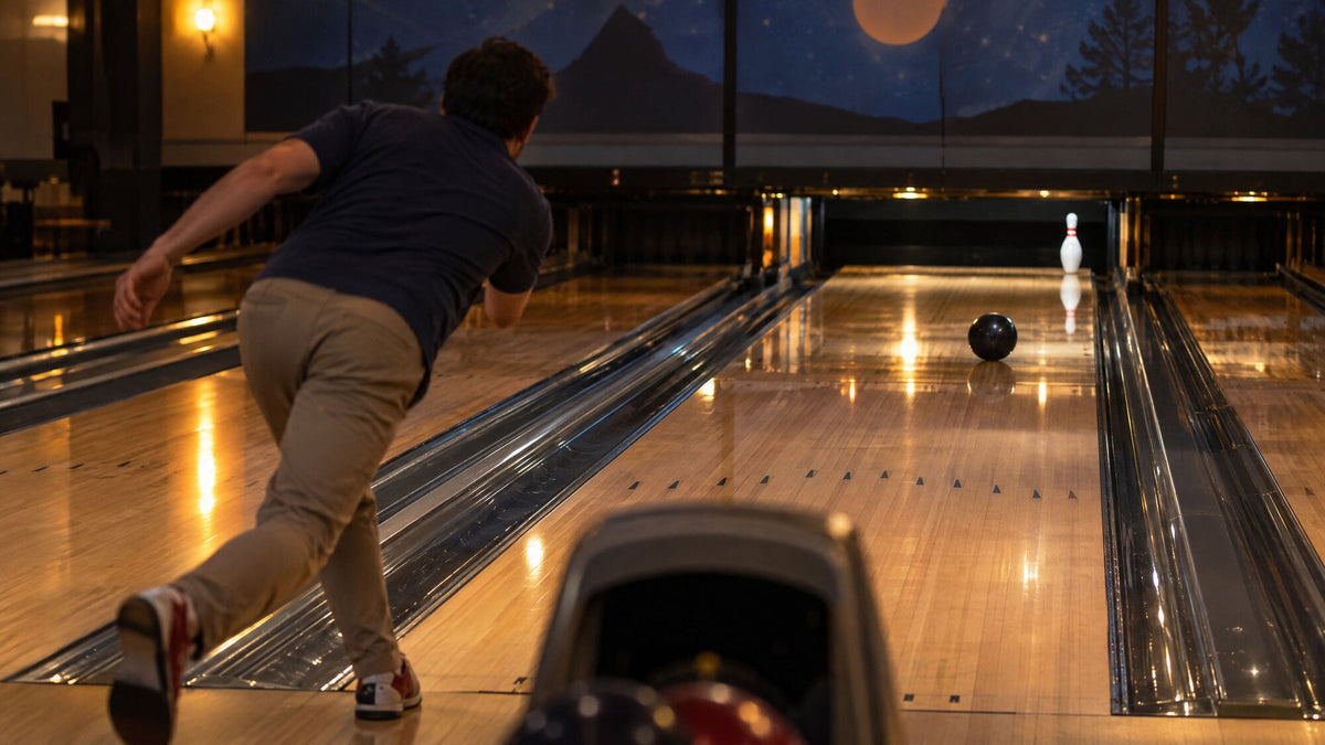 A bowler releasing the ball toward a lone 10 pin standing at the far right of the lane