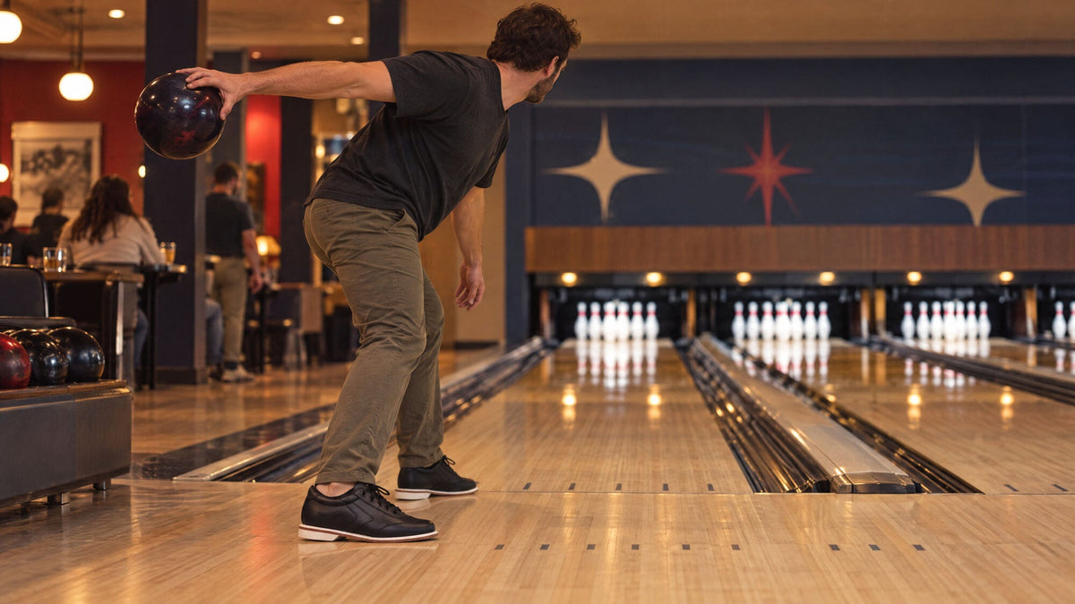 Bowler in BOWLIO Nero bowling shoes at the top of the backswing, shoulders square to the lane