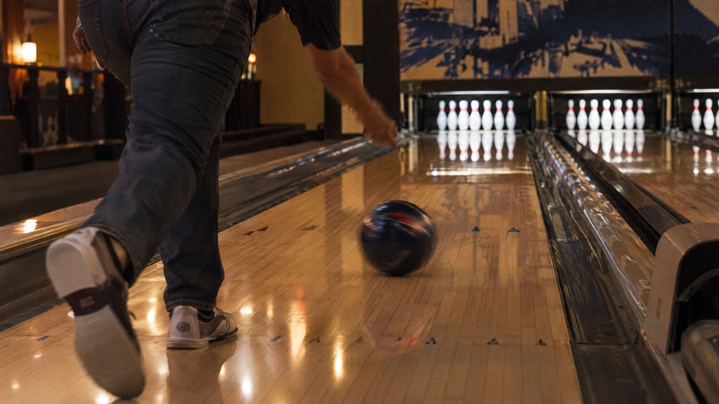 Bowling ball rolling down the lane just after the release, the pins ahead